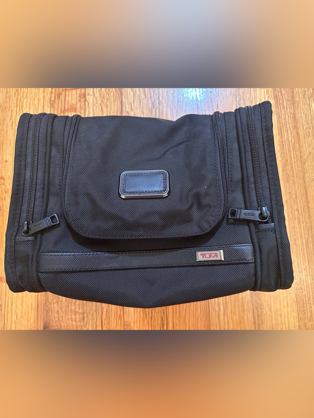 Tumi  hanging travel kit  with hook for hanging.